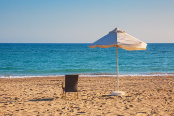 Empty sandy beach in sunny weather under blue sky in not season time