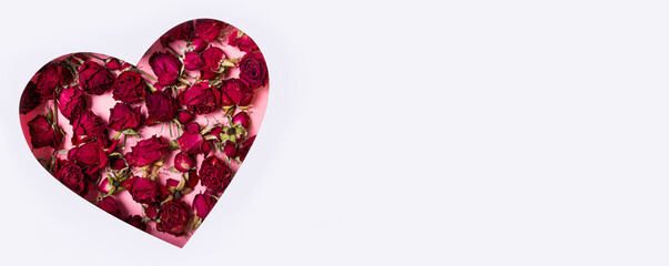 Heart with roses on a white background. International Women's Day, March 8 or Valentine's Day. Postcard, greetings for the holidays. View from above. Banner. Copy space.