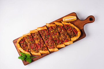 Turkish dish Pide with minced meat and vegetables on a white background