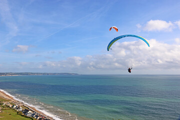 Paragliders flying above Beesands in Devon	
