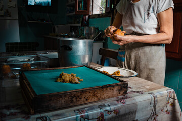 chef preparing food in the kitchen, peeling quince