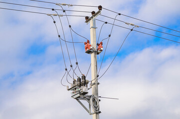 Concrete pole with power lines against the sky. High voltage.Providing the metropolis with...