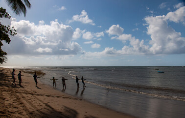 fishermen hauling in the fishing net at dawn