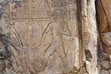 Hieroglypic painted carvings on wall at the ancient egyptian temple in Luxor. Egypt.
