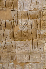 Hieroglypic painted carvings on wall at the ancient egyptian temple in Luxor. Egypt.