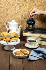 Fried Makrout or makroud - Algerian semolina, dates and honey sweets, traditional North Africa sweet food for islam with coffee and hand holding lantern. ramadan concept 