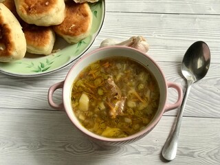 Buckwheat soup with meat and pies with garlic are prepared for lunch or breakfast
