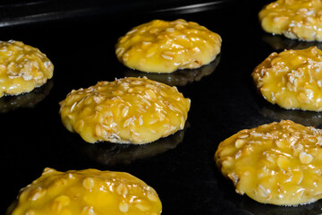 Process of cooking many homemade crunchy oatmeal cookies on metal sheet in oven - close up view. Dessert, cookery, baking, gastronomy and food concept
