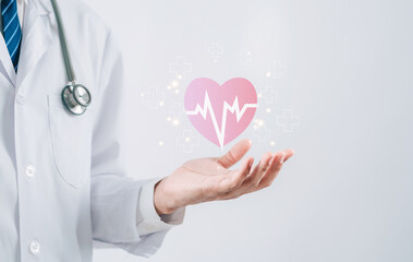Doctor in white coat holding heartbeat icon for positive healthcare insurance symbol concept,...