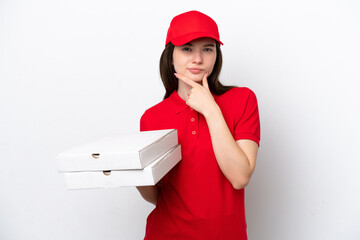 Young Russian pizza delivery picking up pizza boxes isolated on white background thinking