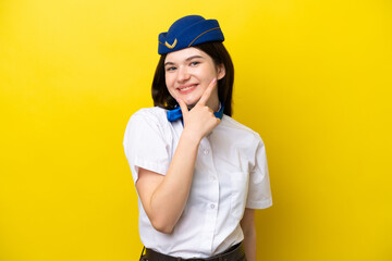 Airplane stewardess Russian woman isolated on yellow background smiling