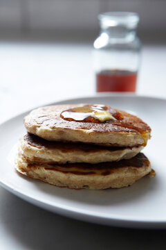 Close-up of Stack of Pancakes with Maple Syrup on Plate