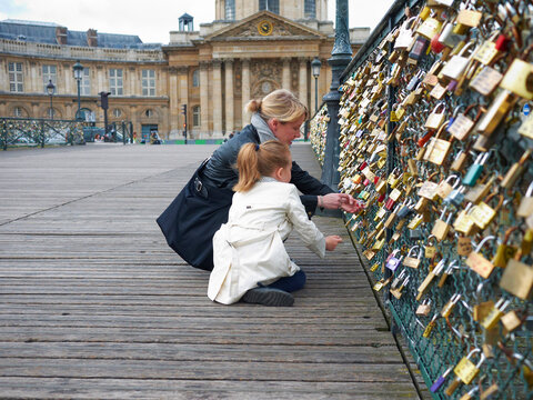 Mother and Daughter looking at Love Locks on Pont Des Arts, Paris, France