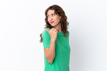 Young woman with curly hair isolated on white background pointing to the side to present a product