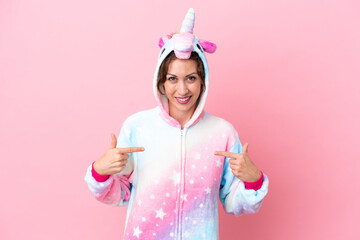 Young caucasian woman with unicorn pajamas isolated on pink background proud and self-satisfied