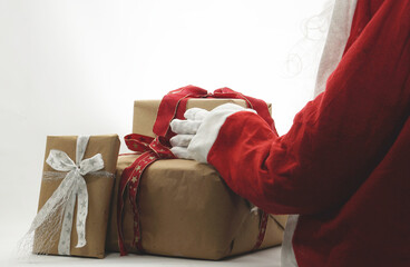 Santa Claus with Christmas gifts, red coat and white gloves and brown wrapping paper