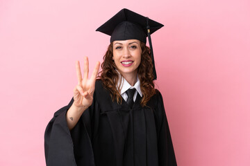 Young university graduate woman isolated on pink background happy and counting three with fingers