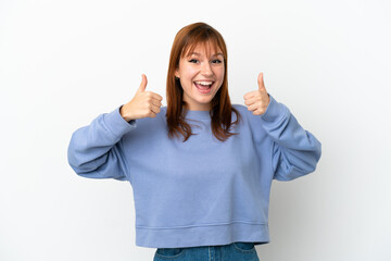 Redhead girl isolated on white background giving a thumbs up gesture