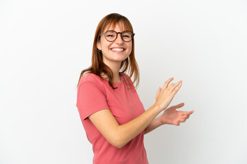 Redhead girl isolated on white background applauding