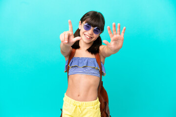 Little caucasian kid going to the beach isolated on blue background counting seven with fingers