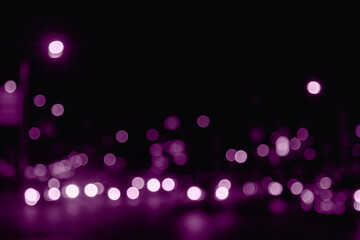 Background of night street with defocused light cars and street lamps. Abstract backdrop of bokeh blurred purple lights at city life. Concept of cityscape backgrounds for design. Copy text space