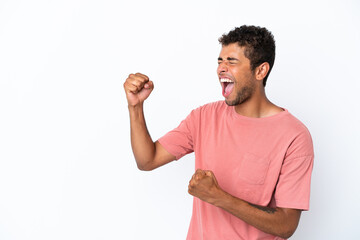 Young handsome Brazilian man isolated on white background celebrating a victory