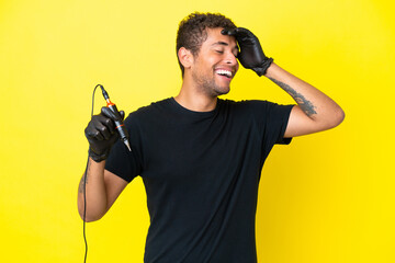 Tattoo artist Brazilian man isolated on yellow background smiling a lot