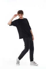 young man in black t-shirt and jeans dancing