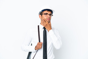 Architect brazilian man with helmet and holding blueprints having doubts