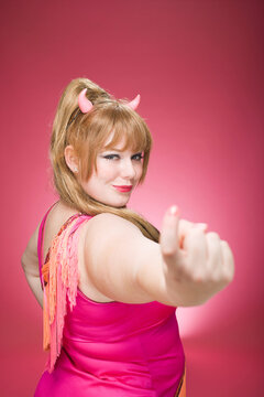 Portrait of Woman Wearing Devil Horns Making Hand Gesture