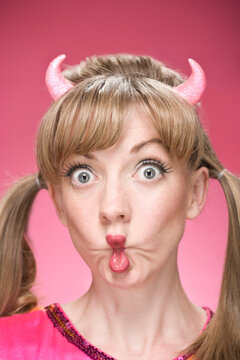 Portrait of Woman Wearing Devil Horns and Making Faces