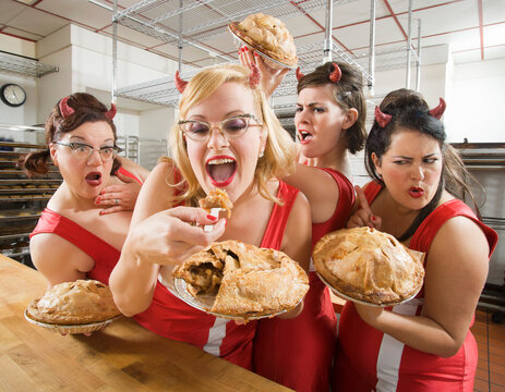 Women Wearing Devil Horns at a Bakery, Oakland, Alameda County, California, USA