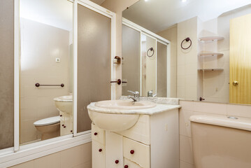 Bathroom with classic and old furniture with shower screen with mirror and large frameless mirror on the wall