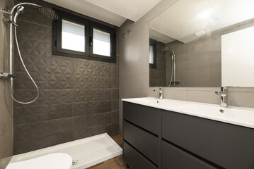 Modern designer bathroom with a walk-in shower without a screen, double white porcelain sinks and a frameless mirror on the wall