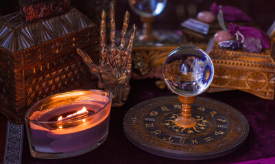 Fototapeta na wymiar Astrology and esoteric concept. Altar with zodiac signs some stuff for horoscope, candles and mystical atmosphere