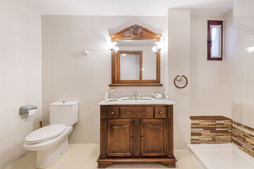 Bathroom with rustic-style wooden furniture and mirror with matching wooden frame and shower cabin with glass screen