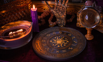 Astrology and esoteric concept. Altar with zodiac signs some stuff for horoscope, candles and...