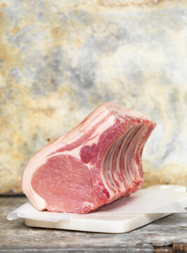 Rack of Raw Pork Chops on Parchment and Marble Slab, Studio Shot