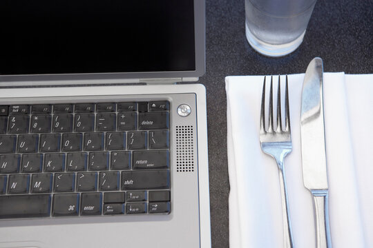 Laptop Next to Place Setting