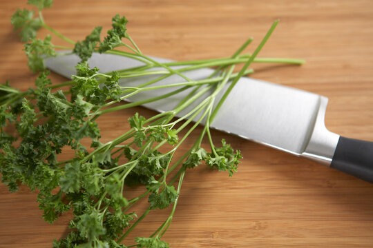 Knife and Parsley on Cutting Board
