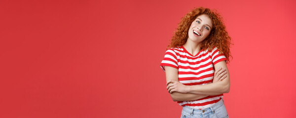 Cheerful carefree redhead playful relaxed curly girl tilt head smiling happy cross arms chest wanna fill summer vacation perfect holiday memories standing red background striped t-shirt - obrazy, fototapety, plakaty