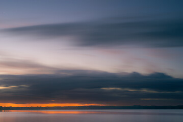 Naklejka na ściany i meble Cloudy dawn over lake in summer