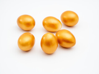 Golden eggs on a white background. Golden chicken eggs.