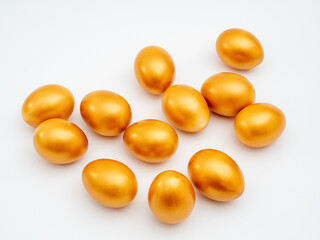 Golden eggs on a white background. Golden chicken eggs.