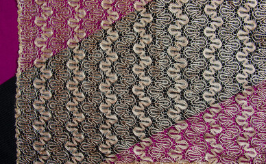 Beige openwork lace on a black-burgundy background