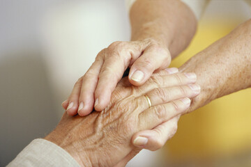 Close Up of Senior Couple With Clasped Hands