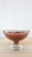 Homemade chocolate mousse on a glass. Vertical photo