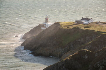 lighthouse on the rocky shore of Howth Peninsula