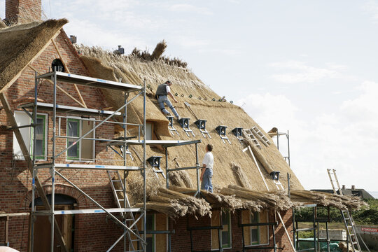 Roofers on Rooftop, Sylt, Germany