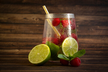 Cold water with mint, raspberry, lime on old background